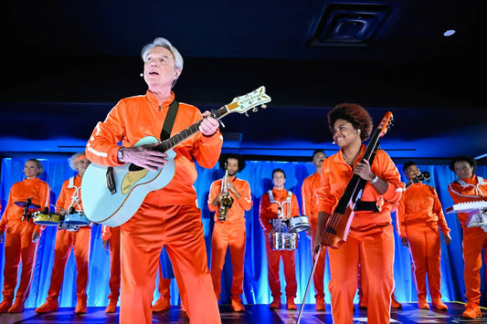 David Byrne Performs New Single ‘What Is The Reason for It?’ on Fallon, Featuring a Sea of Orange Tracksuits